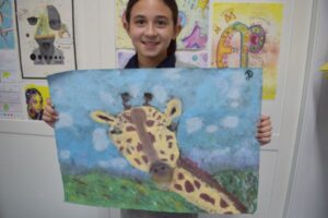 Student with giraffe painting