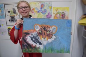 Student with tiger painting