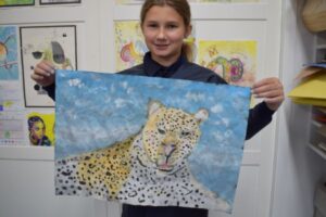 Student with leopard painting